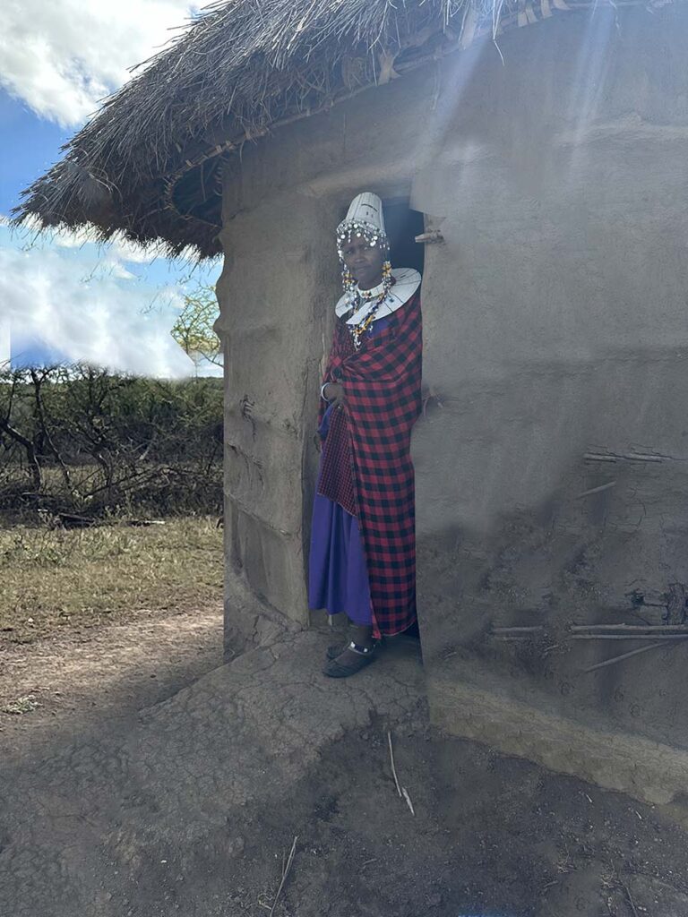 Woman in the door of her Maasai village home